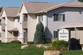 Neenah apartment for rent - a white building with a sign in front of it