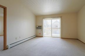 Neenah apartment for rent - an empty living room with a sliding glass door
