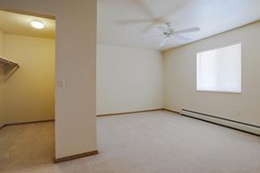 Neenah apartment for rent - an empty room with a ceiling fan and a window