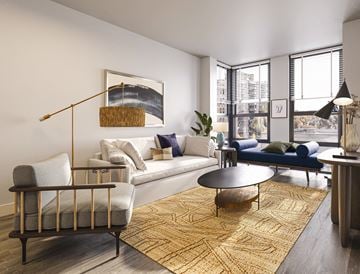 Rockville apartment for rent - A living room with a white couch, blue couch, and a large painting on the wall.