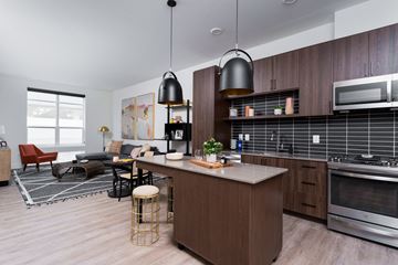 Ashburn apartment for rent - A modern kitchen with dark wood cabinets and a large island.