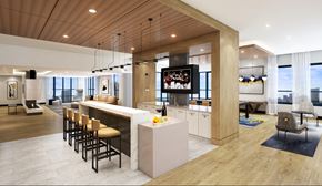 Rockville apartment for rent - A modern kitchen with a bar area and a view of the city.
