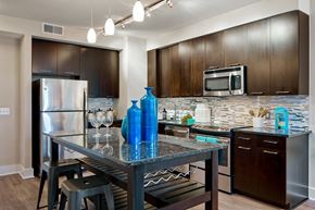Rockville apartment for rent - a kitchen with stainless steel appliances and a table with blue vases