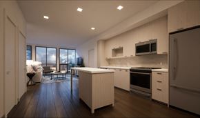 Reston apartment for rent - A modern kitchen with white cabinets and appliances, a wooden floor, and a large window with a view of the sky.