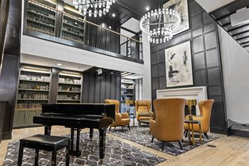 A piano and chairs in the lobby of a building