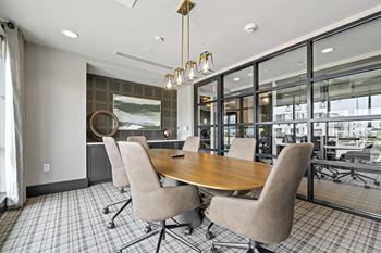 A meeting room with a large table and chairs