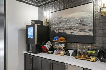 A coffee bar with a television and a painting on the wall