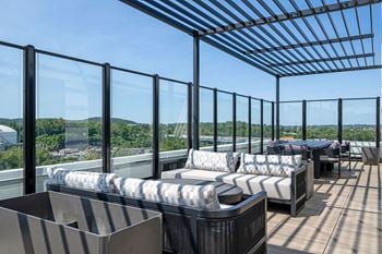 A terrace with couches and tables on a roof