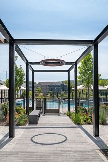 A pool area with a walkway and a bench