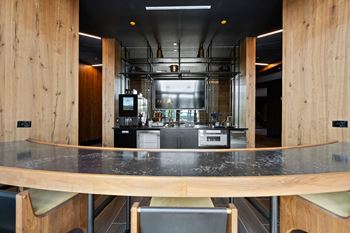 A modern kitchen with a long table and chairs