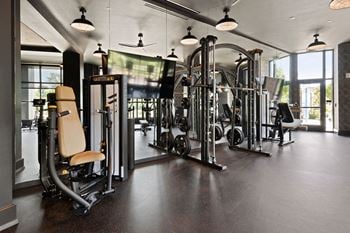 A gym with a variety of equipment including a leg press machine
