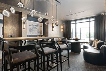 A modern dining room with a long table and chairs