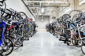 A large room full of bicycles parked in a row