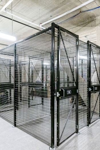 A group of cages in a building with doors