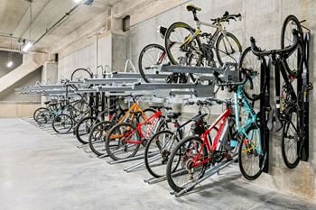 A bike rack full of bicycles in a parking garage