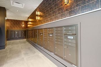 The mail room is equipped with mailboxes and cabinets