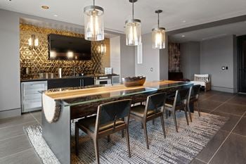 A modern dining room with a wooden table and chairs