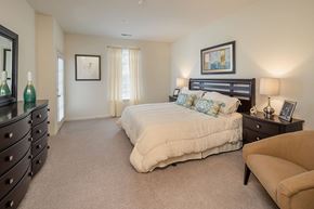 Lansdale apartment for rent - A bedroom with a large bed and a dresser.