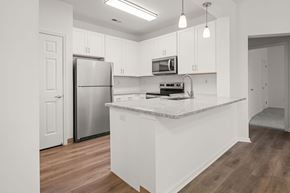 Lansdale apartment for rent - A kitchen with white cabinets and a granite countertop.