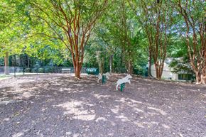 Raleigh apartment for rent - A playground with a slide and swings set in a park.