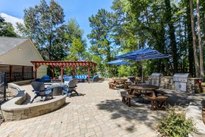 Raleigh apartment for rent - An outdoor lounge with a table and chairs under an umbrella.