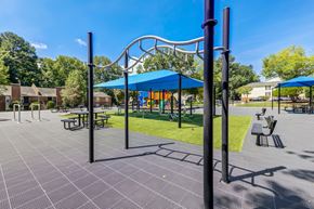 Raleigh apartment for rent - An outdoor gym with bars and a blue canopy.