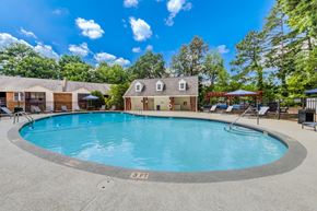 Raleigh apartment for rent - A swimming pool with chairs and umbrellas