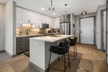 A modern kitchen with a center island and bar stools