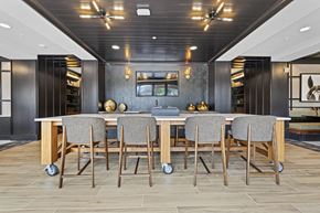 Newtown Square apartment for rent - a kitchen with a long island with a bunch of chairs around it at The Harrison, Newtown Square, PA, 19073