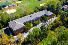Bel Air apartment for rent - a view of a building from above with a golf course and trees