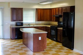 Aberdeen apartment for rent - A kitchen with black appliances and brown cabinets.