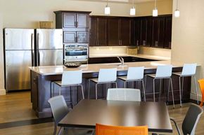 Baltimore apartment for rent - a large kitchen with a table and chairs and a refrigerator