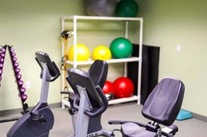 Laurel apartment for rent - a gym with exercise equipment and a shelf of balls