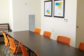 Baltimore apartment for rent - a conference room with a long table and orange chairs