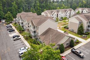 Cambridge apartment for rent - An aerial view of Cambridge Commons with cars parked in the parking lot.