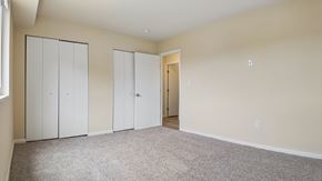 Washington apartment for rent - Three white doors are in a room with carpeted floor.
