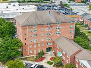 Towson apartment for rent - Brick 55+ apartment building at Park View at Towson with landscaped entrance and parking
