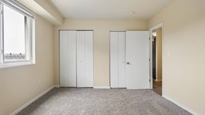 Washington apartment for rent - A room with two white closet doors and a carpeted floor.