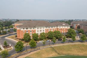 Baltimore apartment for rent - a large brick building with trees in front of it