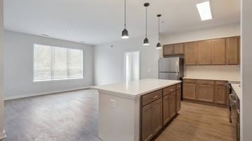 Columbia apartment for rent - A kitchen with wooden cabinets and a white countertop.