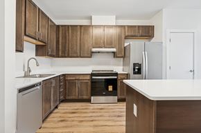 Richmond apartment for rent - A kitchen with wooden cabinets and a white countertop.