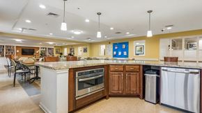 Ellicott City apartment for rent - A kitchen with a white island and wooden cabinets.