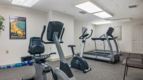 York apartment for rent - A gym with a treadmill, elliptical trainer and a stationary bike.