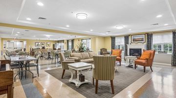 Ellicott City apartment for rent - A spacious living room with a dining table and chairs.