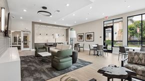 Richmond apartment for rent - A modern living room with a grey sofa, a green armchair, and a coffee table.