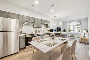 Washington apartment for rent - A modern kitchen with a dining table set for two.