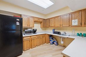 Columbia apartment for rent - a kitchen with a black refrigerator freezer next to a sink