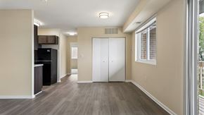 Washington apartment for rent - A spacious room with a white door and a black refrigerator.