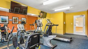 Ellicott City apartment for rent - A gym with treadmills, elliptical machines, and other exercise equipment.