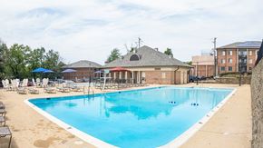 Washington apartment for rent - A large outdoor swimming pool with a building in the background.